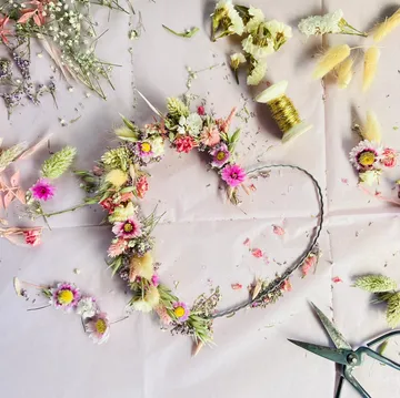 Floral crown crafting with dried flowers and twine.