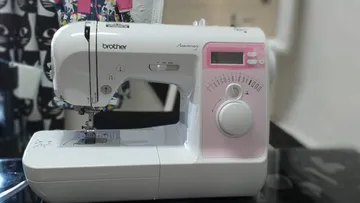 Sewing machine with digital display on table.