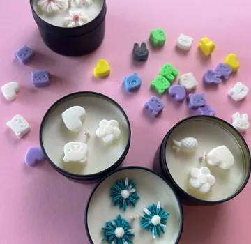 Decorative candles with colorful wax shapes.