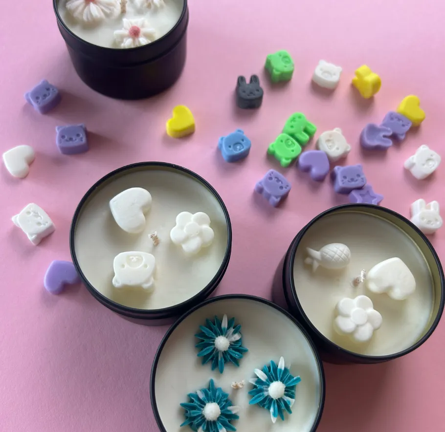 Decorative candles with colorful wax shapes.