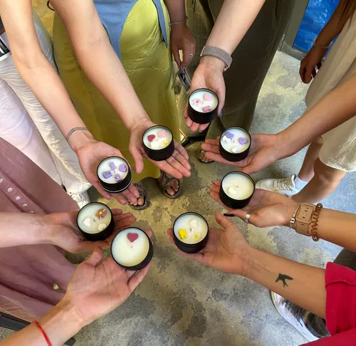 People holding candles with decorations in hands.