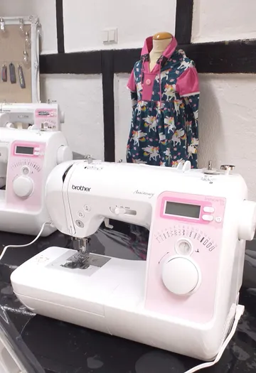 Sewing machines and mannequin in sewing workshop.