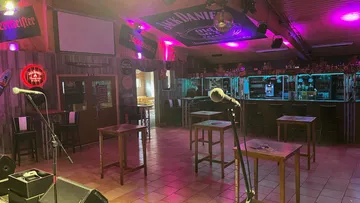 Empty bar with microphones and neon lights.