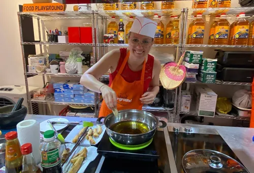 Person cooking in kitchen, smiling, preparing food.