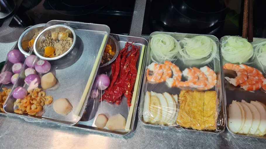 Prepared ingredients on trays in a kitchen.
