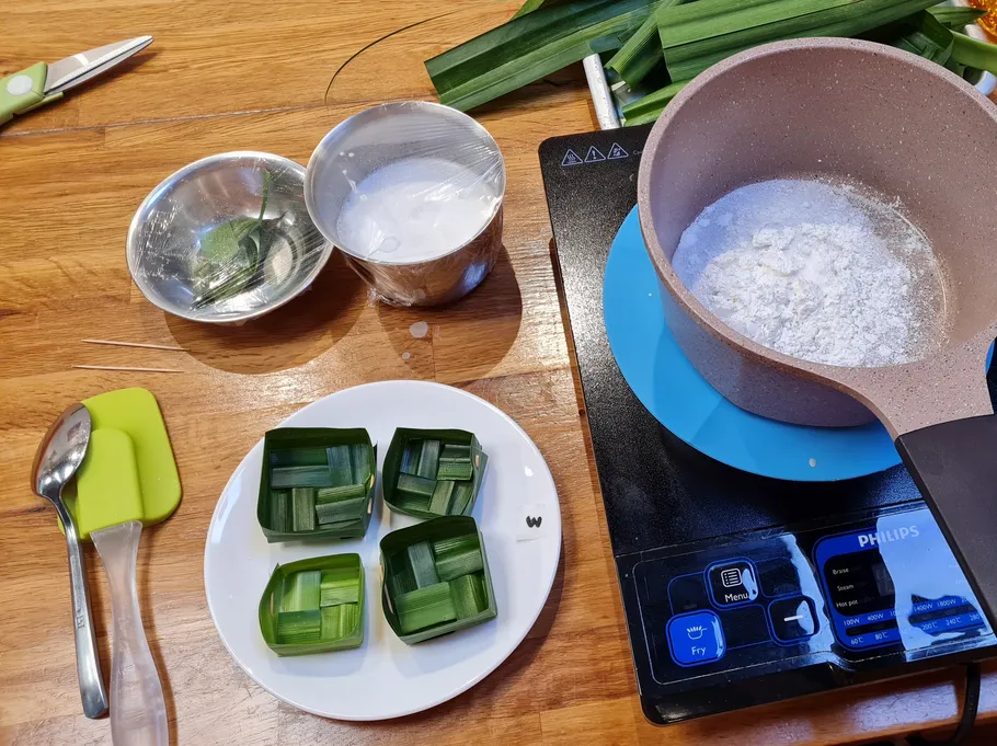 Ingredients and cookware on wooden kitchen counter.