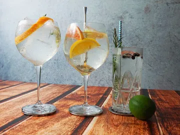 Three glasses of refreshing drinks on a table.