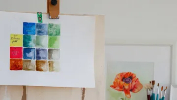 Color chart on easel near flower painting.