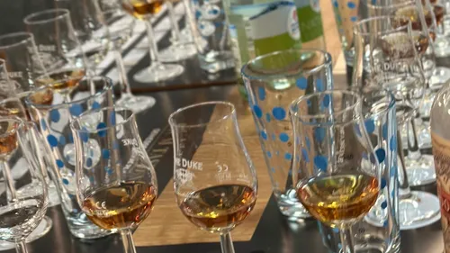 Glasses with amber liquid on a table.