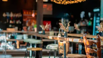 Empty café with wooden tables and chairs.