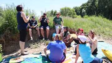 Group of people having a picnic outdoors.