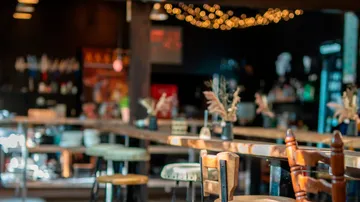 Empty pub with wooden chairs and tables.