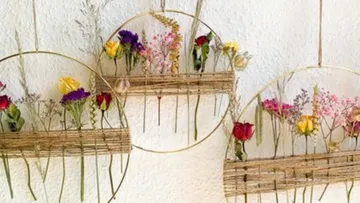 Decorative floral wall hangings on textured background.