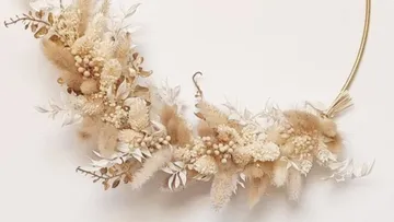 Floral wreath with neutral tones on wall.