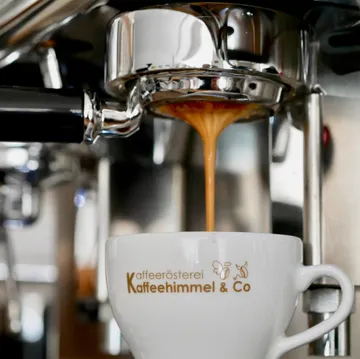 Espresso pouring into cup from machine.