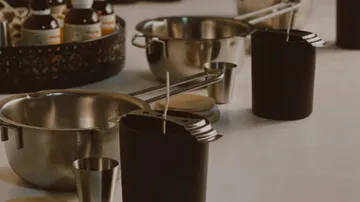 Candle making supplies on a table.