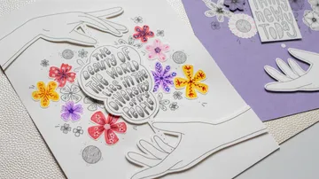 Papierkunst-Hände halten bunte Blumen und Text.