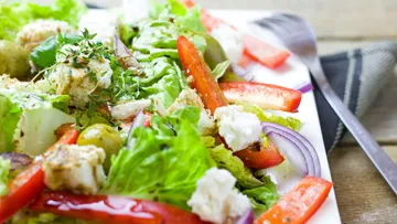 Fresh salad with lettuce, peppers, and feta cheese.