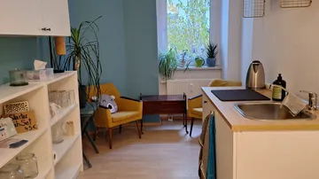 Cozy kitchen with chairs and plants.