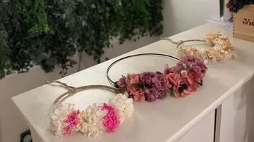 Floral wreaths displayed on a white table.