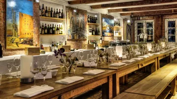 Rustic dining room with long wooden tables.