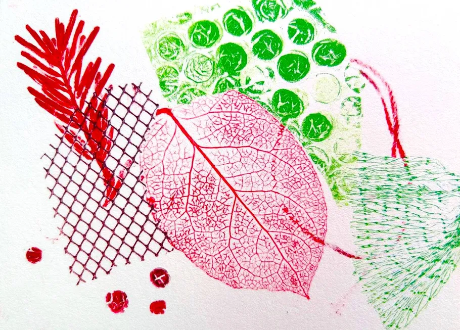 Colorful leaf and plant imprints on paper.