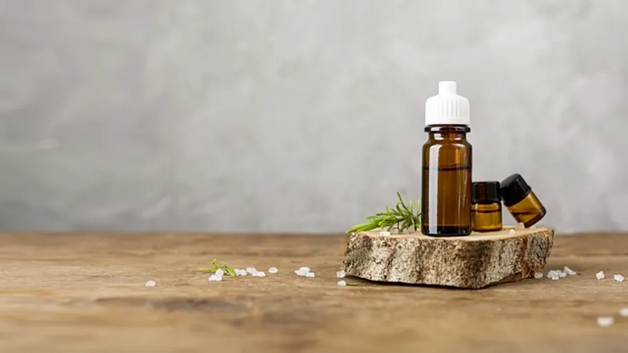 Essential oil bottles on wooden surface.