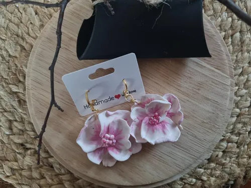 Floral earrings on wooden board, handmade card.