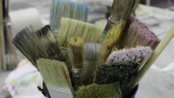 Assorted paintbrushes in a container.
