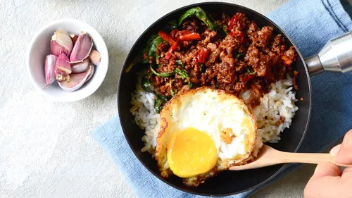 Fried egg and minced beef on rice dish.