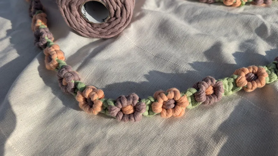 Crochet flowers on fabric in sunlight.