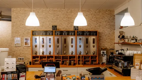 Coffee shop interior with coffee dispensers.