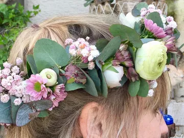 Flower wreath on a head with colorful, fresh flowers.