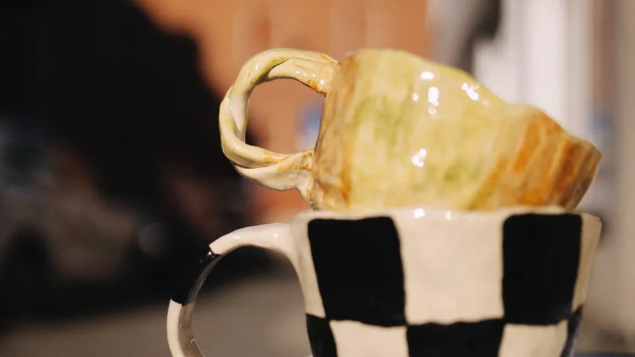 Stacked cups with artistic designs outdoors.