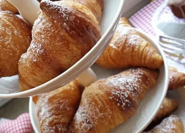 Croissants on a tiered serving plate.