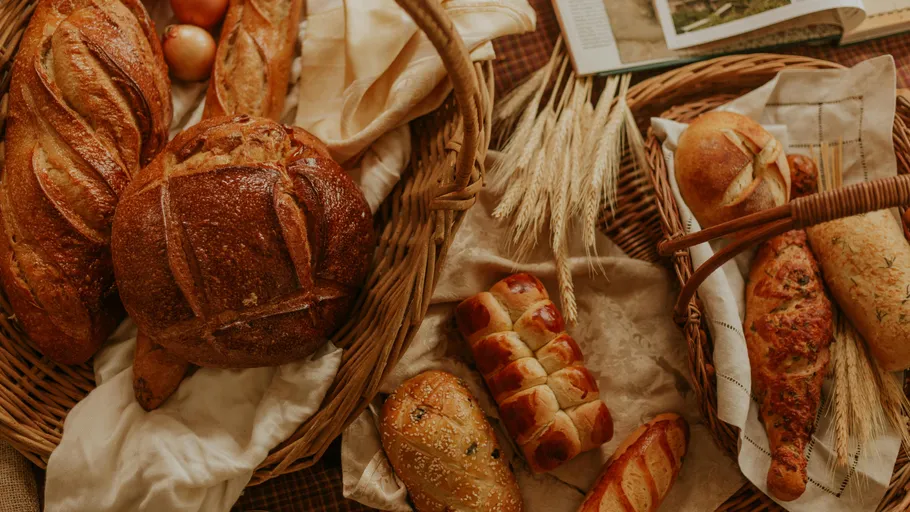 Various breads in baskets on a table.