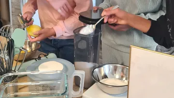 People preparing ingredients in a kitchen.