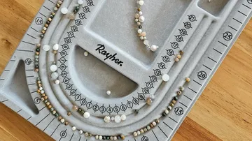 Beads arranged on a crafting board.