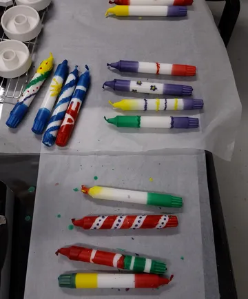 Bunt verzierte Kerzen auf Pergamentpapier.