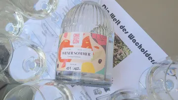 Bottle labeled 'Wiener Sommer' with glasses nearby.