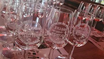 Wine glasses with raised text in restaurant.