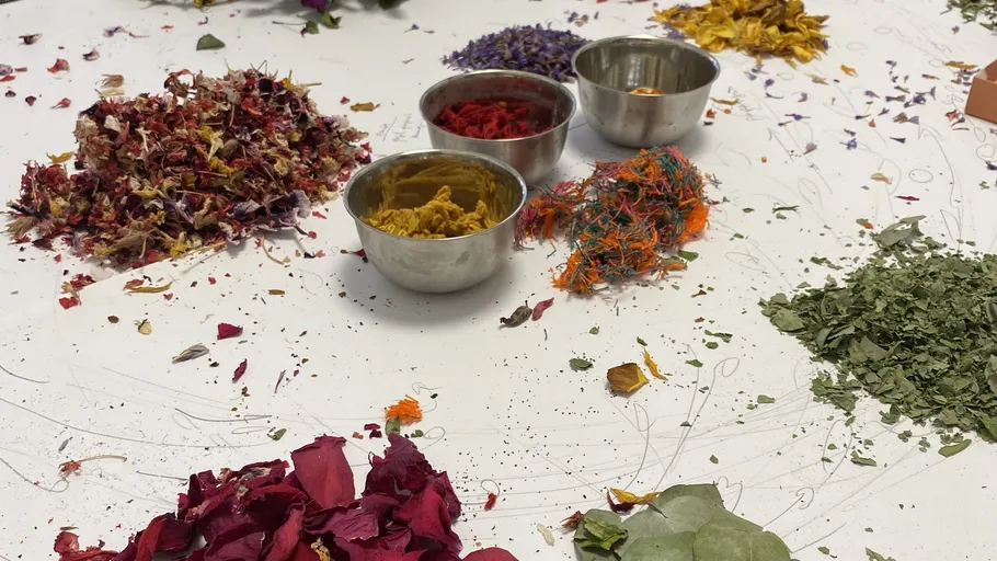Various dried flowers arranged around metal bowls.