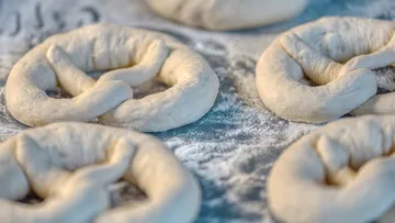 Unbaked pretzel dough on floured surface.