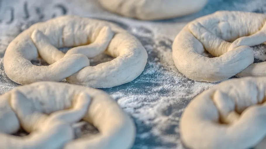 Unbaked pretzel dough on floured surface.