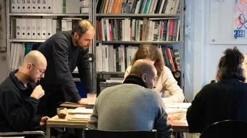 People collaborating around a table in an office.