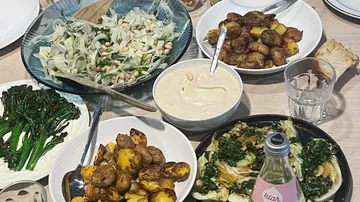 Table with various dishes and beverages.