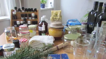 Jars, bottles, and ingredients on kitchen table.