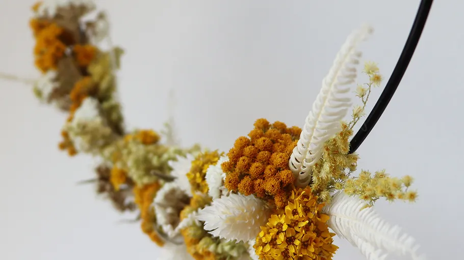 Yellow and white floral arrangement on wire.