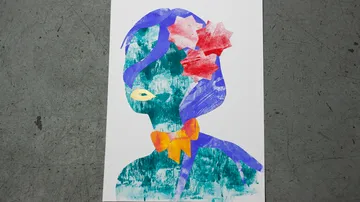 Colorful abstract portrait on gray surface.