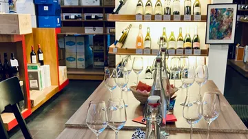 Wine bottles and glasses on wooden table.